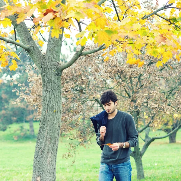 Man walking outside in a park — Stock Photo, Image