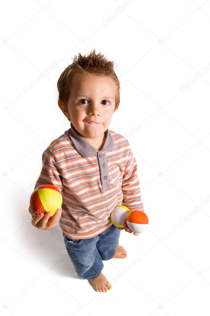 2 years old happy kid playing with balls