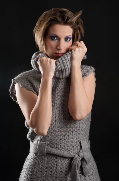 Sensual beautiful girl portrait with wool dress against black background — Stock Photo, Image