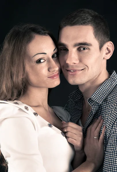 Happy young couple. Close up studio portrait on black background — Stock Photo, Image