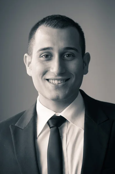 Portrait of young happy businessman. Black and white image — Stock Photo, Image