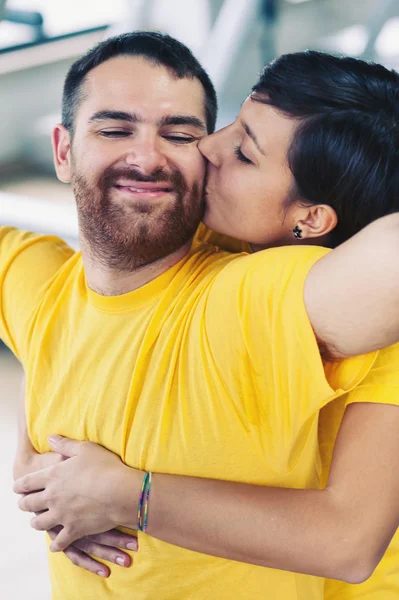 Junges Paar umarmt und küsst sich in der Turnhalle — Stockfoto
