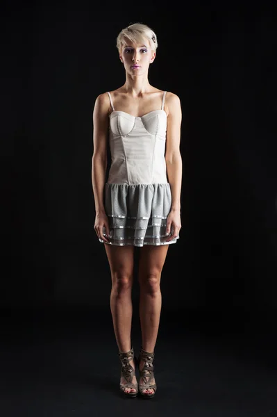 Young girl portrait with short dress isolated against black background — Stock Photo, Image