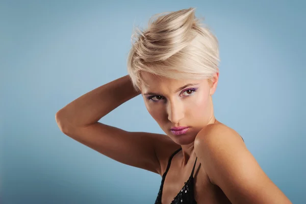 Young woman portrait over blue background — Stock Photo, Image