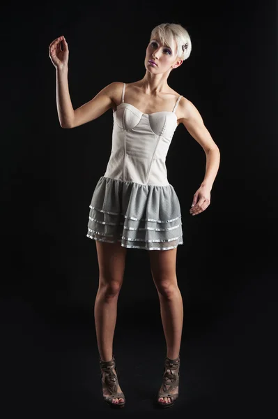 Young girl portrait with short dress isolated against black background Royalty Free Stock Photos