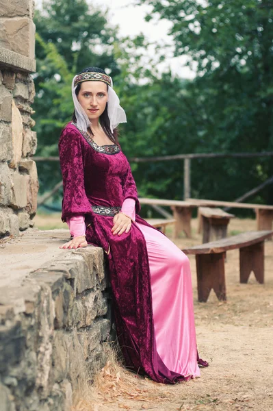 Beautiful girl wearing a burgundy medieval dress. Full body — Stock Photo, Image