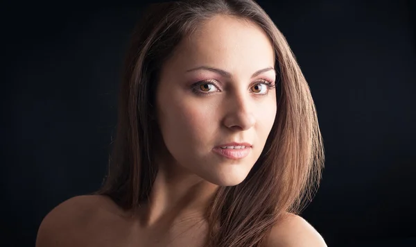 Intense woman close up portrait against dark background — Stock Photo, Image