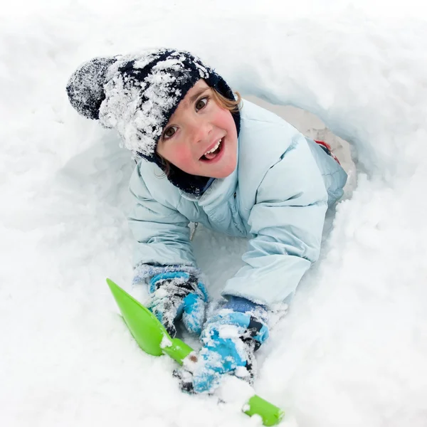Funny portrait of young kid playing in the snow Stock Image