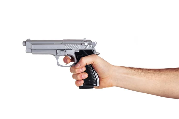 Mão branca segura arma isolada no fundo branco . — Fotografia de Stock