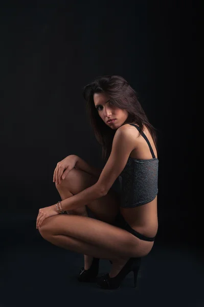 Sexy woman portrait wearing top corset against dark background. — Stock Photo, Image