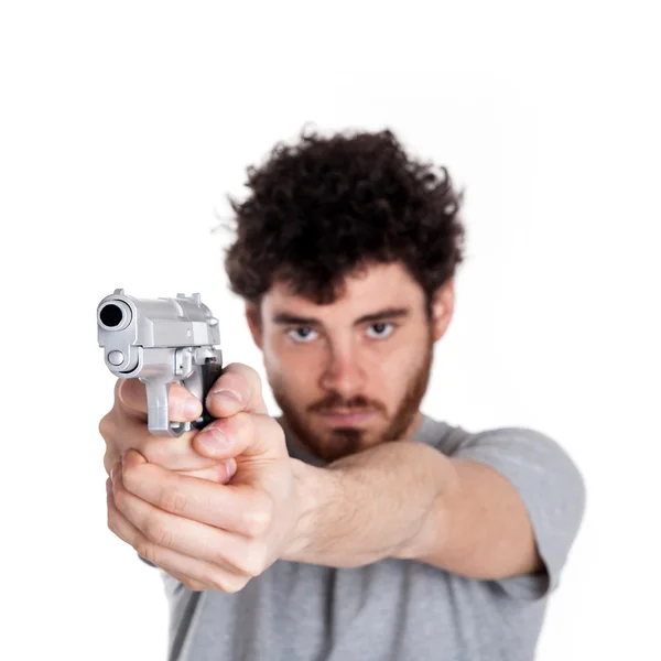 Νεαρή δολοφόνος, δείχνοντας ένα πιστόλι πάνω από το λευκό φόντο. — Φωτογραφία Αρχείου