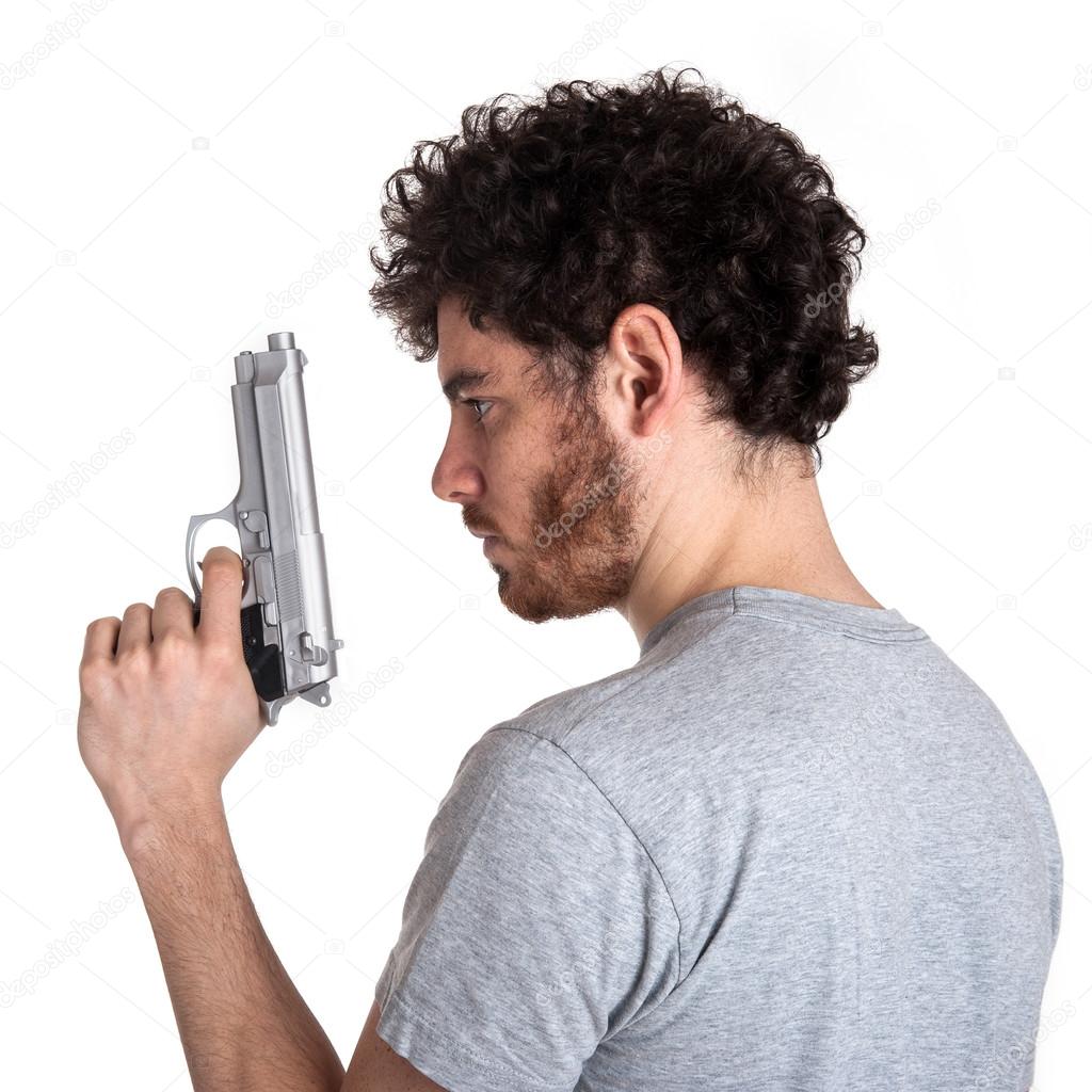 Young killer with gun portrait over white background.