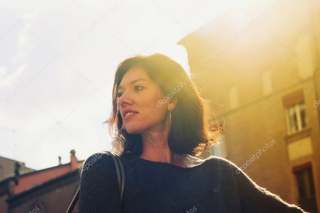 Beautiful woman portrait outdoors with back light.