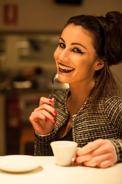 Elegante mujer sonriente tomando café en un bar. Tiempo nocturno . — Foto de Stock