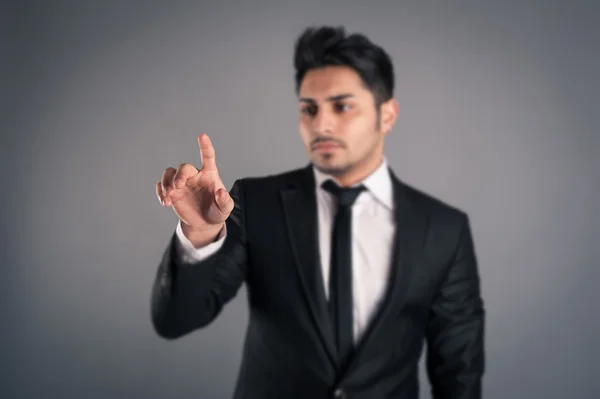 Young businessman indicating with finger. — Stock Photo, Image