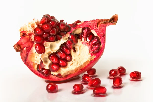 Pomegranate on a white background with grains — Stock Photo, Image