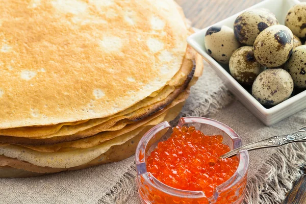 Pancakes with caviar and quail eggs — Stock Photo, Image