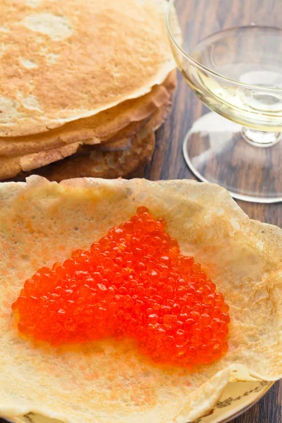 Pancakes with red caviar in a heart shape — Stock Photo, Image