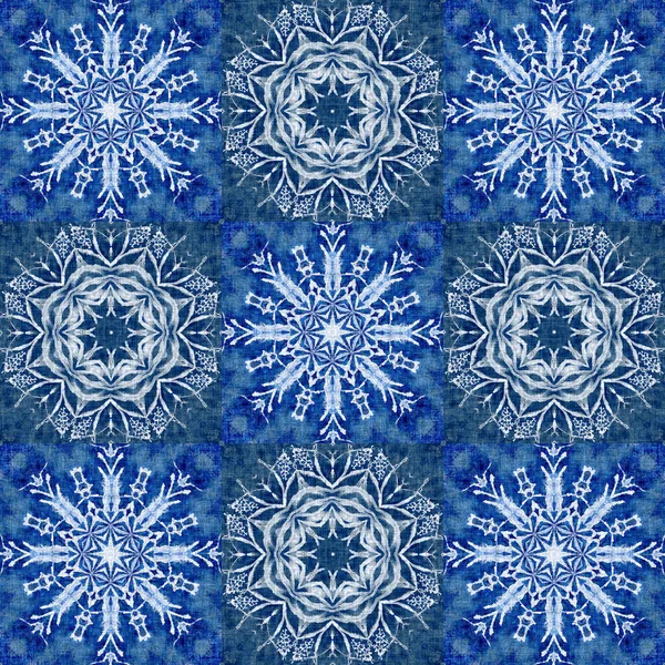 Indigo blue snow flake patchwork pattern background. Frosty painterly effect seamless backdrop. Festive cold holiday season wall paper tile