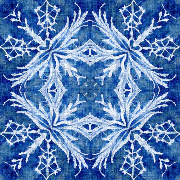 Indigo blue snow flake pattern background. Frosty batik painterly effect seamless backdrop. Festive cold holiday season wall paper tile