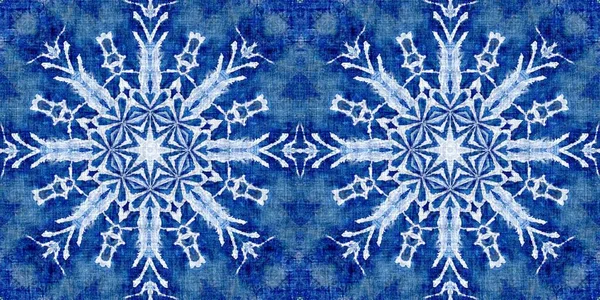 Indigo blue snow flake border background. Frosty batik painterly effect seamless edging. Festive cold holiday season ribbon.