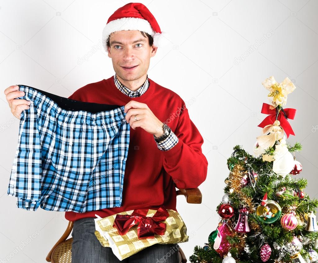 Man unwrapping a Christmas gift