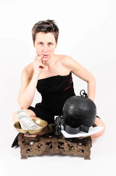 Woman with scales, money and prison ball — Stock Photo, Image