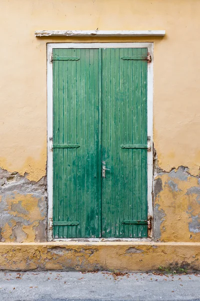 Weathered green door shutters