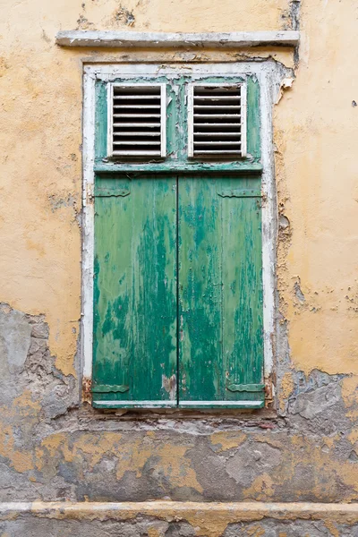 Weathered green window shutters Royalty Free Stock Images
