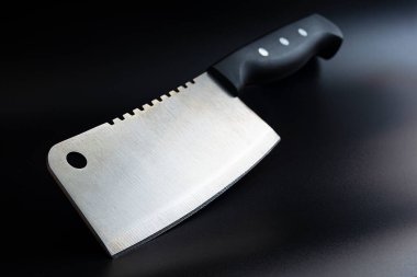 meat ax, kitchen knife on black background, with copy space