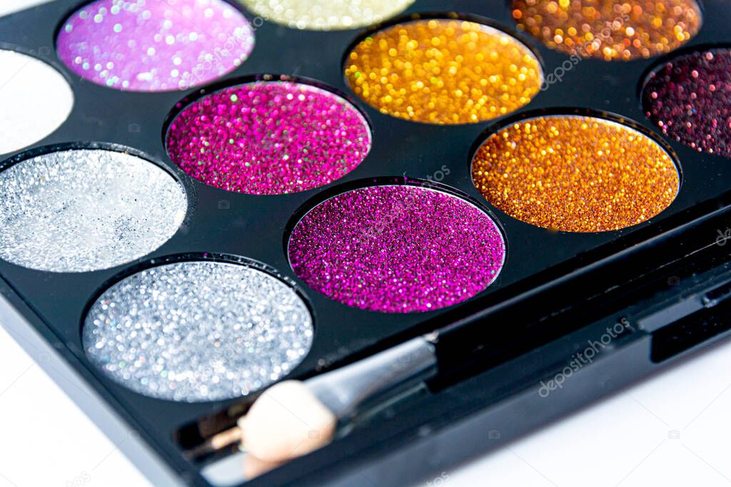 selective focus beautiful colors of closeup makeup glittering background