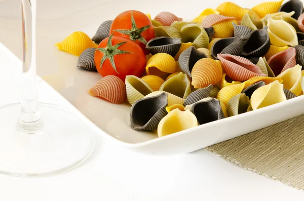 Italian multicolor pasta with wine glass — Stock Photo, Image