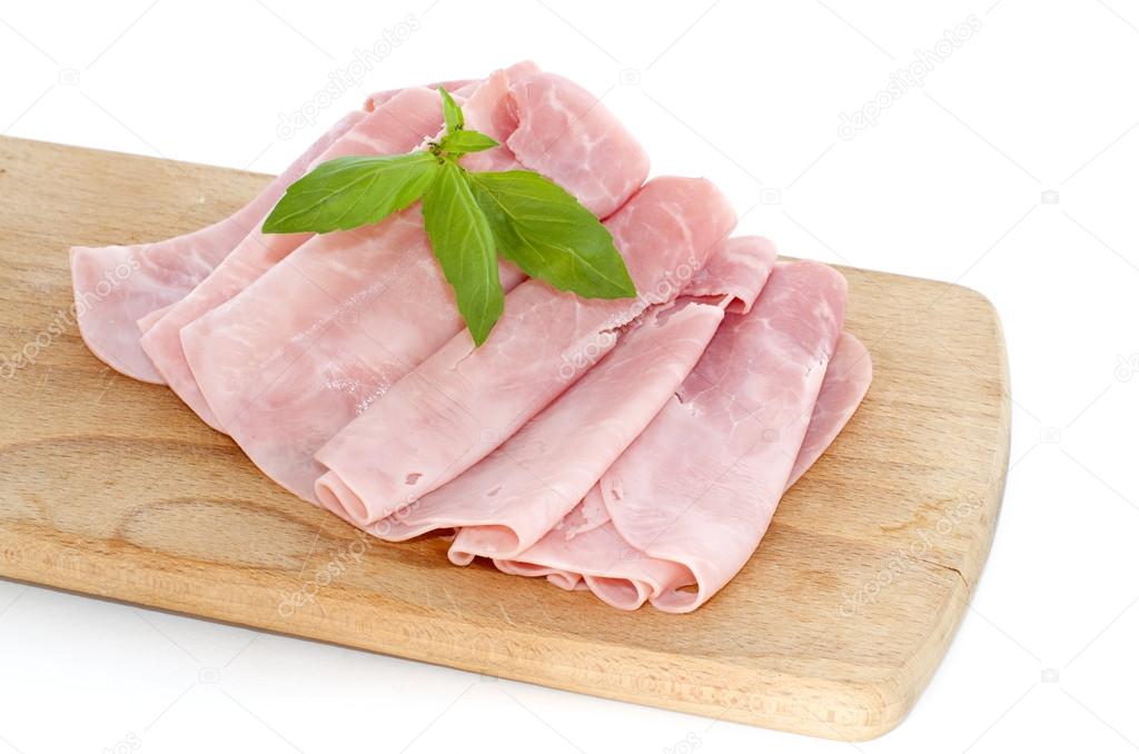 Baked ham with slices on wooden board