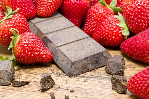 Erdbeeren rohe Schokolade auf dem Holztisch — Stockfoto