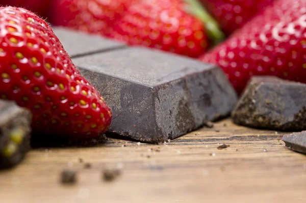 Strawberries raw chocolate on whooden table — Stock Photo, Image