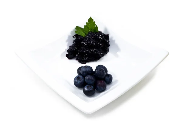Blueberries and blueberry jam in a white bowl. — Stock Photo, Image