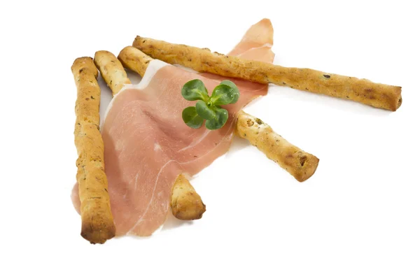 Grissini sticks isolated on white background with ham — Stock Photo, Image