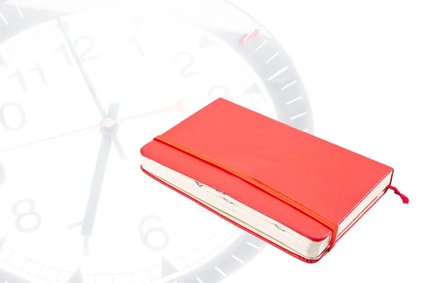 Red journal with staples and clock background — Stock Photo, Image