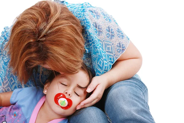 Affectionate Mother kissing her sleeping daughter — Stock Photo, Image