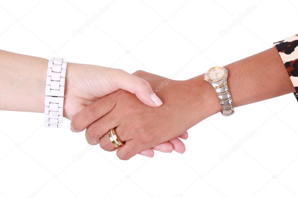 Handshake of two multiracial business women. Isolated on white b