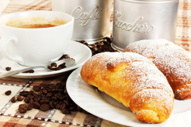 Brioches with cup of coffee and sugar clipart