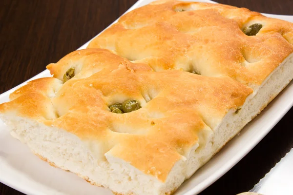 Focaccia with green olives, focaccia is flat oven baked Italian — Stock Photo, Image