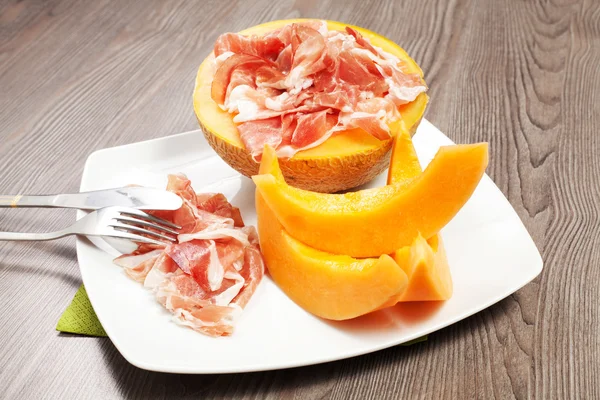 Ham and melon on the white dish — Stock Photo, Image