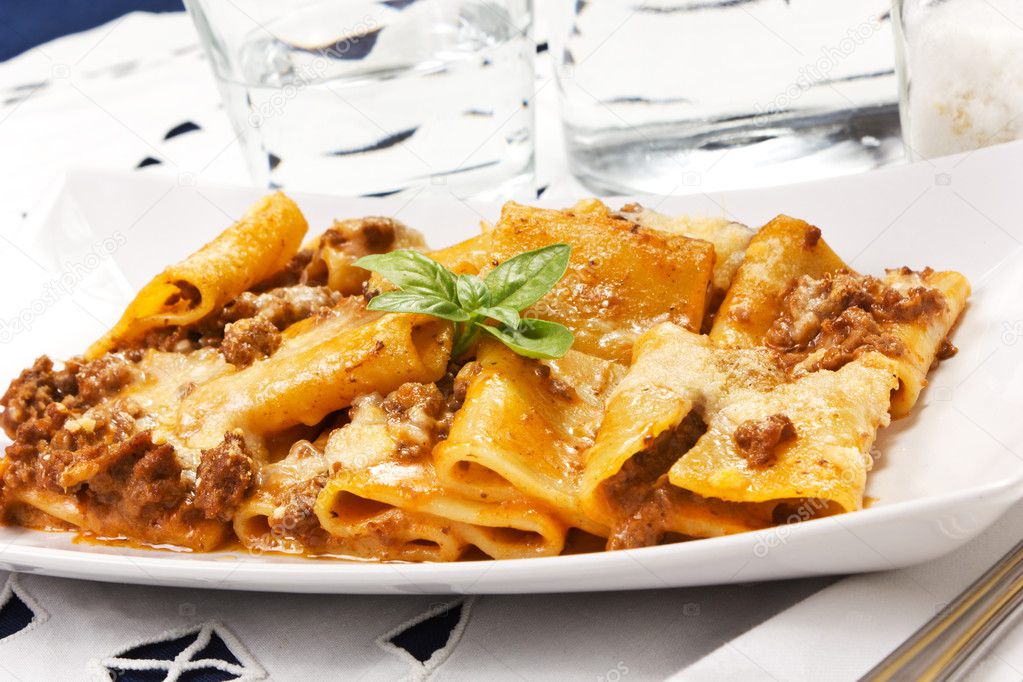 Pasta with meat sauce and bechamel in the dish on the table