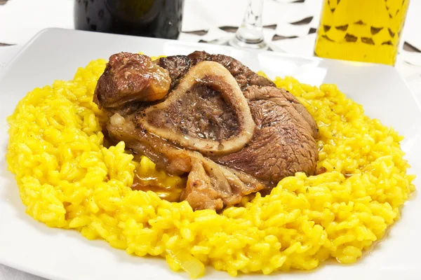 Osso buco bivine meat with rice with saffron — Stock Photo, Image