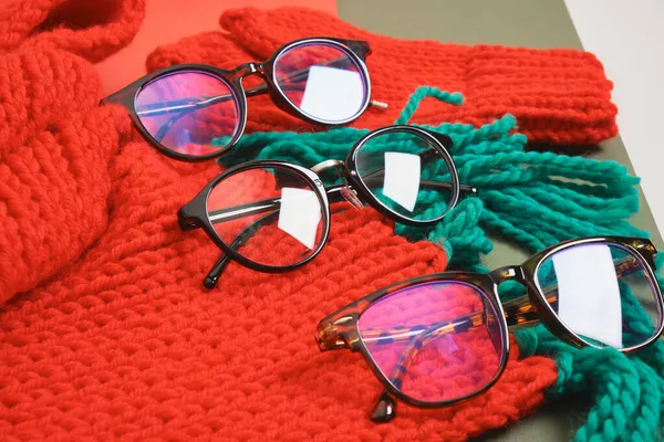 Several Different Stylish Eye Glasses Red Knitted Scarf Christmas Sale — Stock Photo, Image