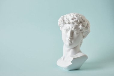 bust of david replica on light blue background copy space, copy of work by michelangelo