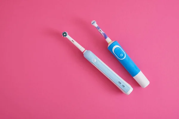 Two Electric Blue Toothbrushes Bright Pink Background Oral Hygiene Concept — Stock Photo, Image