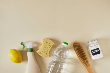 Soda kutusu, sprey şişesi, sirke, limon, ahşap fırça ve bej arka plan fotokopi alanı, çevre temizleme konsepti, ev temizleme üst görüşünde toksik olmayan deterjan kullanımı