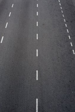 Beyaz çizgileri olan asfalt yol